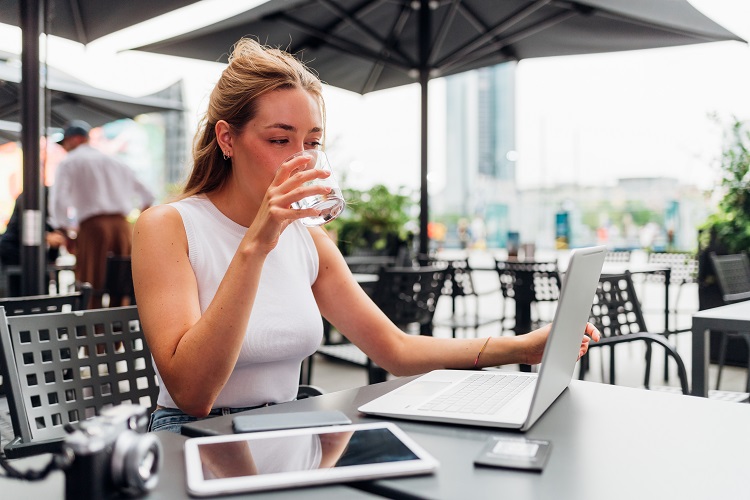 Woman working remotely in a coffee shop
